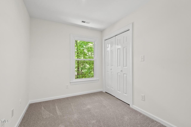 120 Kingston Dr, Chapel Hill, NC 27514 - unfurnished bedroom featuring baseboards, carpet floors, and a closet