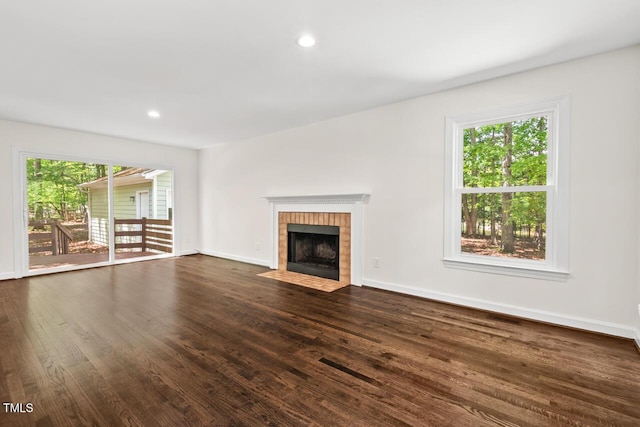 120 Kingston Dr, Chapel Hill, NC 27514 - unfurnished living room with dark wood finished floors, a tiled fireplace, baseboards, and recessed lighting