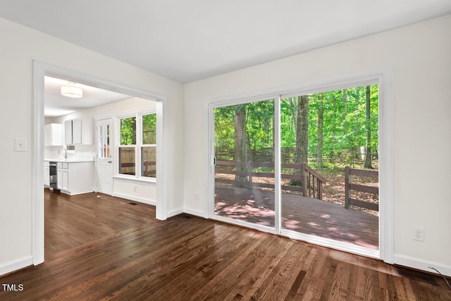 120 Kingston Dr, Chapel Hill, NC 27514 - unfurnished living room featuring baseboards, dark wood finished floors, and plenty of natural light
