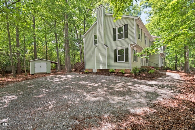 120 Kingston Dr, Chapel Hill, NC 27514 - view of home's exterior with a storage shed, an outbuilding, and a chimney