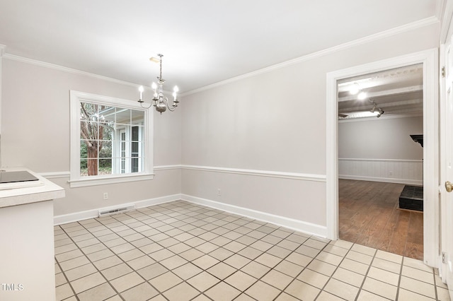 unfurnished dining area with crown molding, light wood-type flooring, and a chandelier