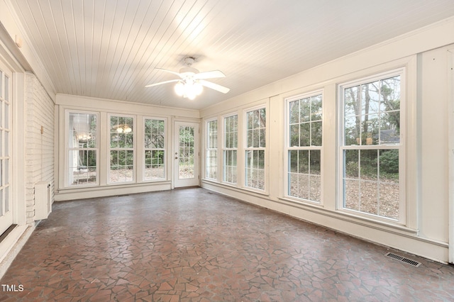 unfurnished sunroom featuring wood ceiling and ceiling fan