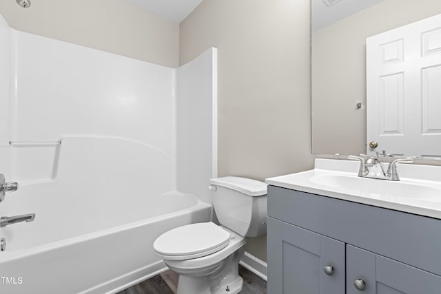 full bathroom featuring wood-type flooring, shower / tub combination, toilet, and vanity