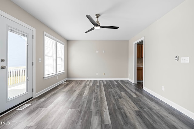 unfurnished room with ceiling fan and dark hardwood / wood-style floors