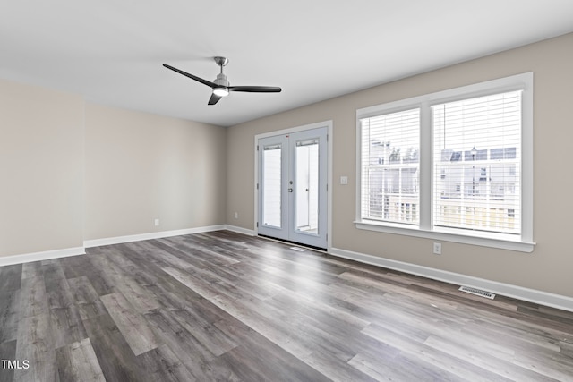 empty room with hardwood / wood-style floors, a healthy amount of sunlight, and french doors