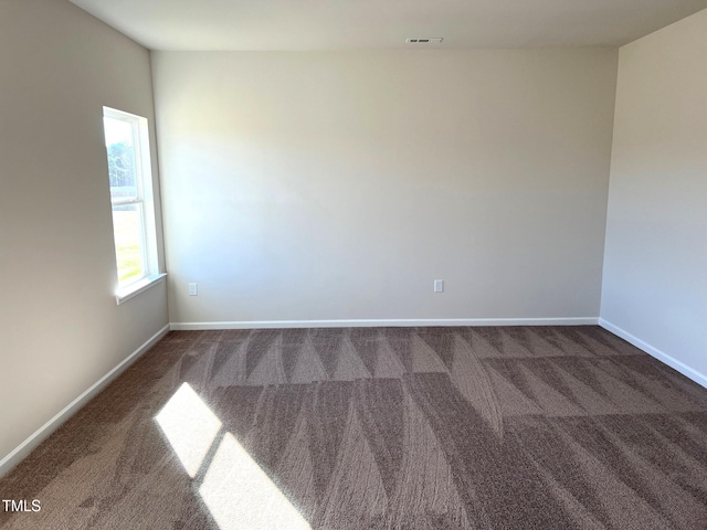 empty room featuring dark carpet