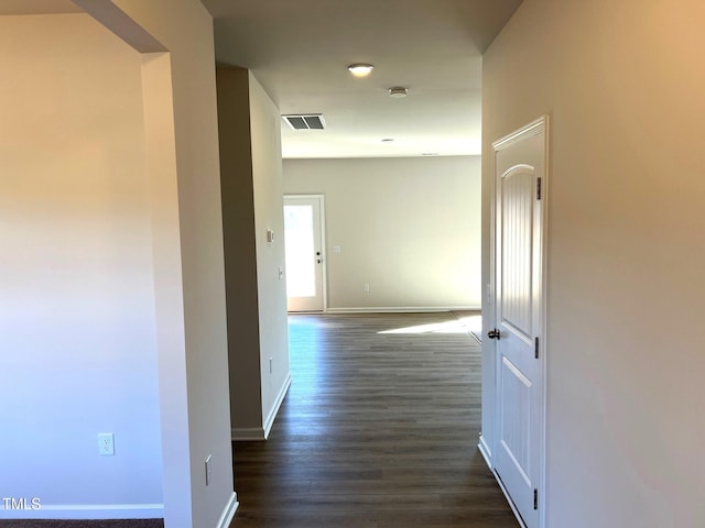 hallway with dark hardwood / wood-style floors