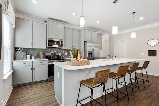 kitchen featuring pendant lighting, a center island with sink, and appliances with stainless steel finishes