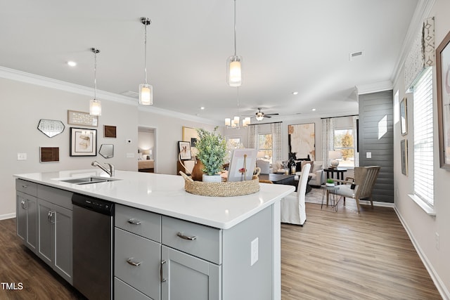 kitchen with sink, gray cabinetry, stainless steel dishwasher, an island with sink, and pendant lighting