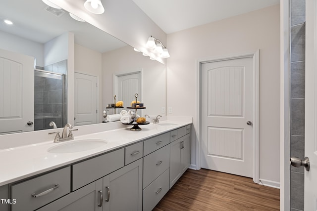 bathroom with walk in shower, wood-type flooring, and vanity