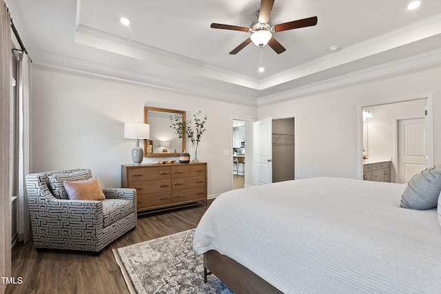 bedroom featuring dark wood-type flooring, a tray ceiling, and crown molding