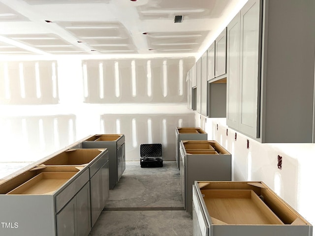 kitchen with gray cabinets and concrete floors