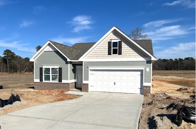 craftsman house featuring a garage, concrete driveway, and brick siding