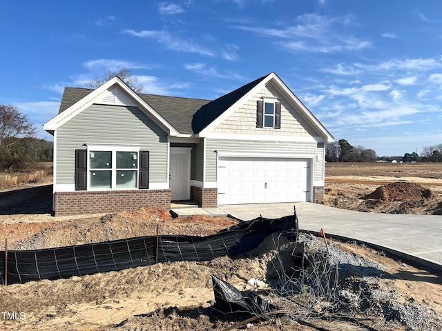 view of front facade with driveway and brick siding