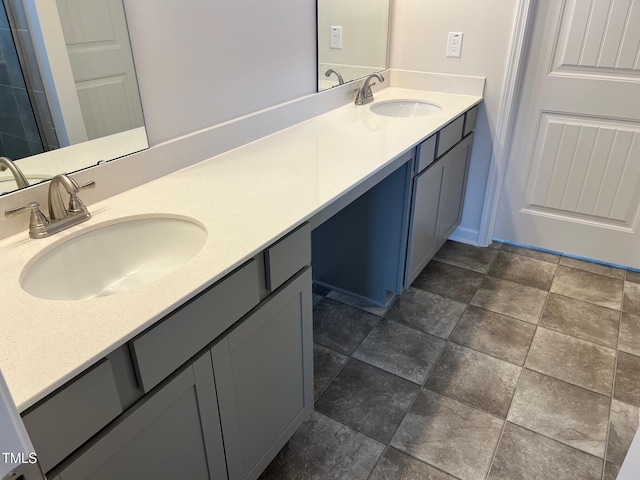 full bathroom with double vanity and a sink