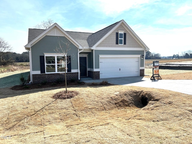 craftsman-style home with a garage, brick siding, and driveway