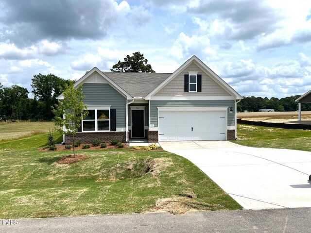 craftsman-style home with a front lawn, driveway, a garage, and brick siding