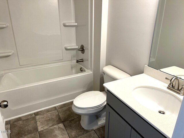 bathroom with stone finish flooring, vanity, toilet, and bathtub / shower combination