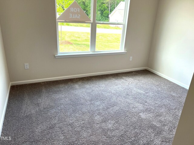 spare room with carpet flooring and baseboards