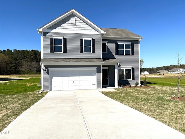 traditional-style house featuring driveway, an attached garage, and a front yard