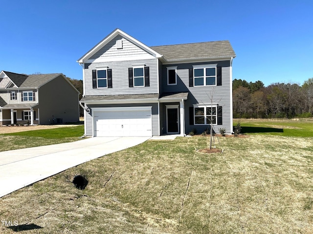 traditional-style home featuring a front yard, concrete driveway, and an attached garage