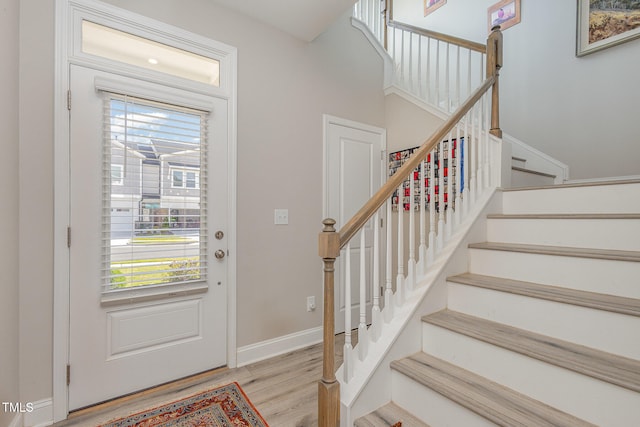 foyer entrance with light hardwood / wood-style floors