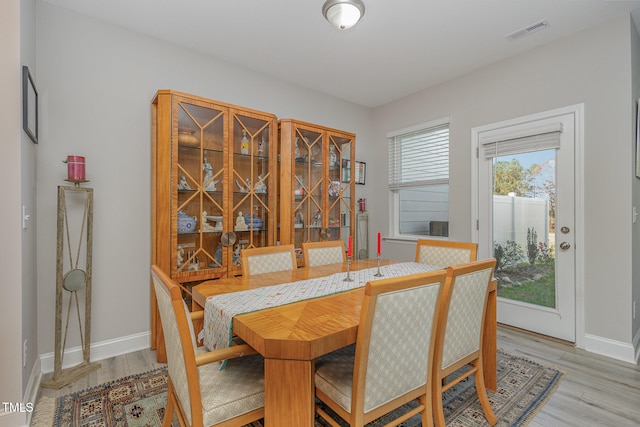 dining space with hardwood / wood-style flooring