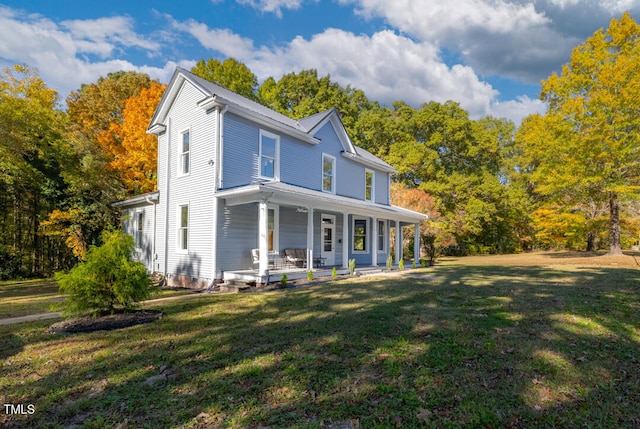 view of front of house featuring covered porch and a front yard