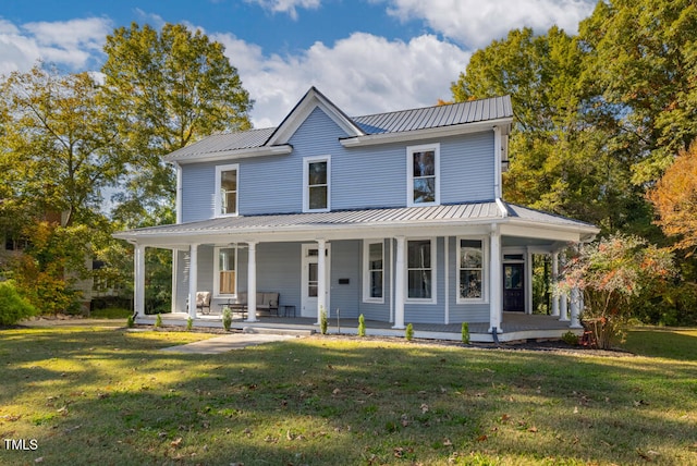 farmhouse-style home featuring a front yard and covered porch