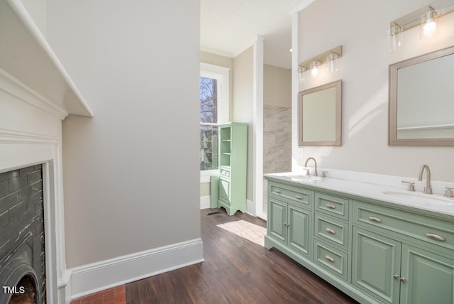 bathroom featuring vanity, crown molding, and wood-type flooring