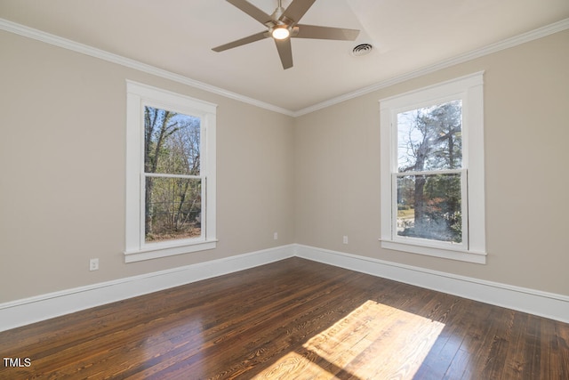 empty room featuring crown molding, dark hardwood / wood-style floors, a healthy amount of sunlight, and ceiling fan