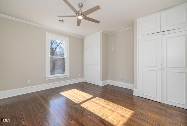 unfurnished bedroom featuring a closet, ceiling fan, ornamental molding, and dark hardwood / wood-style flooring