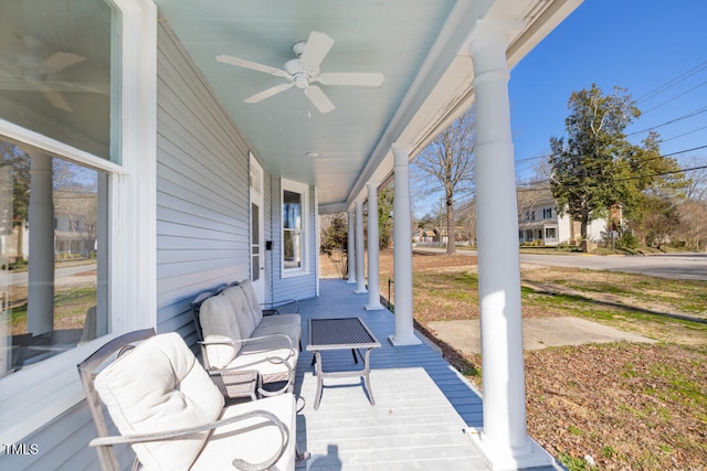 deck with outdoor lounge area and ceiling fan