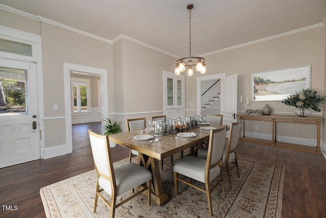 dining space featuring ornamental molding, dark wood-type flooring, and an inviting chandelier