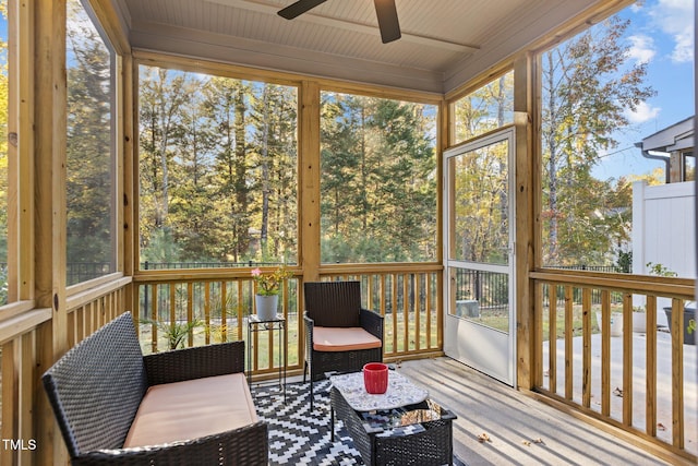 sunroom / solarium with a healthy amount of sunlight and ceiling fan