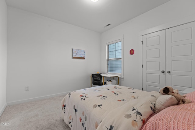 bedroom featuring a closet and light carpet