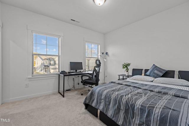 bedroom featuring light colored carpet