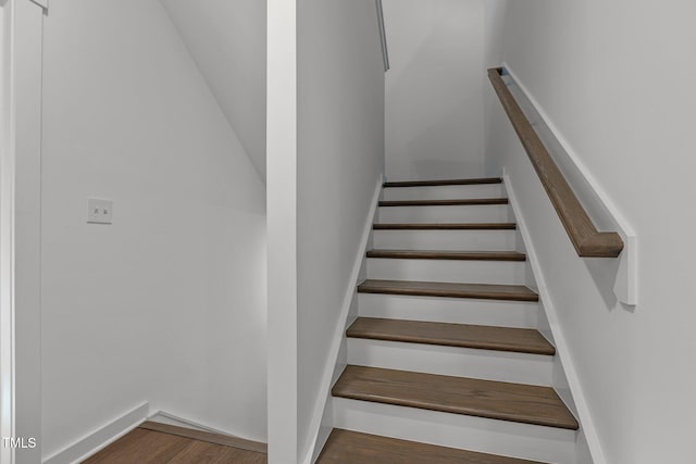 staircase featuring hardwood / wood-style flooring