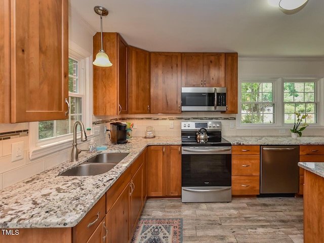 178 Paceville Rd, Selma, NC 27576 - kitchen with appliances with stainless steel finishes, a sink, brown cabinets, decorative backsplash, and ornamental molding