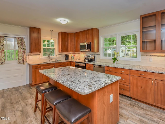 178 Paceville Rd, Selma, NC 27576 - kitchen featuring stainless steel appliances, a sink, brown cabinets, tasteful backsplash, and light wood-style flooring