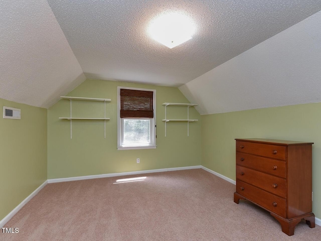 178 Paceville Rd, Selma, NC 27576 - additional living space with a textured ceiling, vaulted ceiling, carpet floors, and baseboards