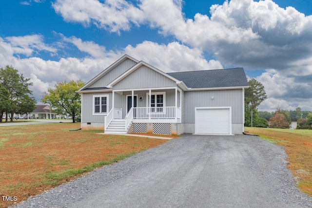 view of front facade with a garage, a porch, and a front yard