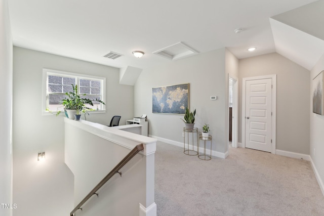 corridor featuring light carpet and vaulted ceiling