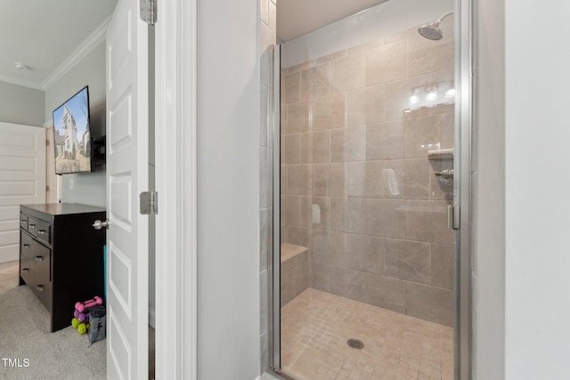 bathroom featuring a shower with door and ornamental molding