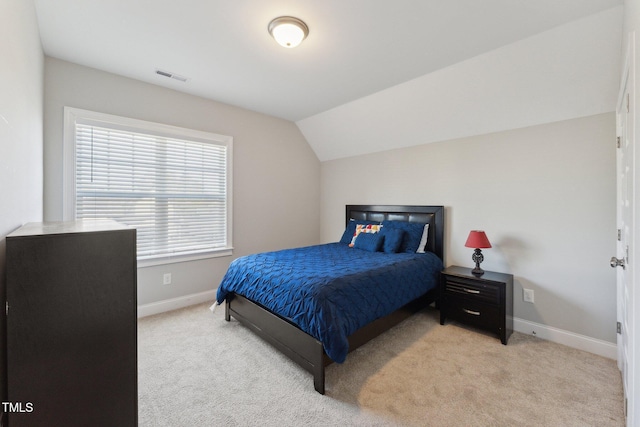 carpeted bedroom featuring vaulted ceiling and multiple windows