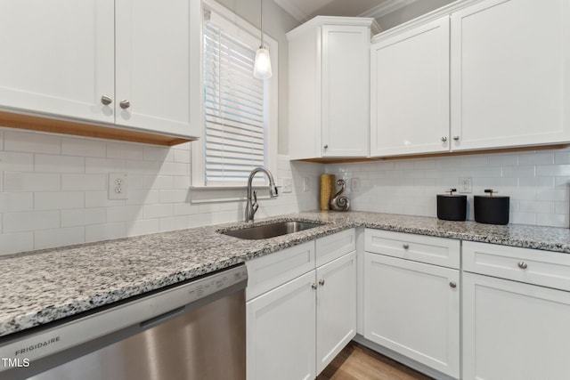 kitchen featuring sink, white cabinetry, stainless steel dishwasher, and backsplash