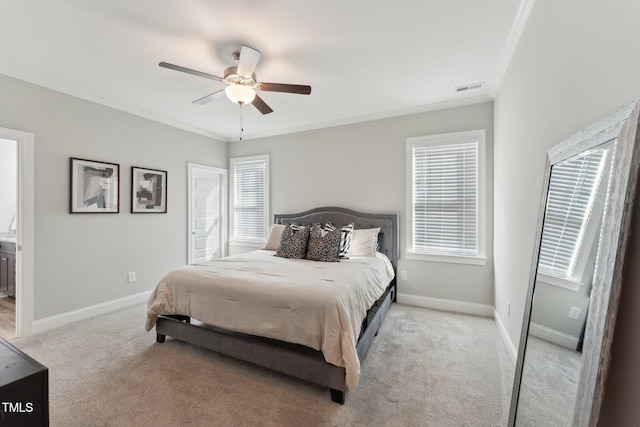 carpeted bedroom with ensuite bath, ceiling fan, multiple windows, and crown molding