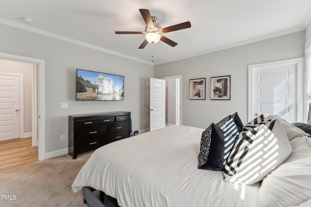 carpeted bedroom featuring ornamental molding and ceiling fan