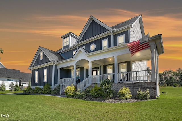 view of front of home with a lawn and covered porch