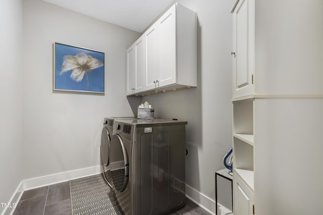 washroom featuring separate washer and dryer and cabinets